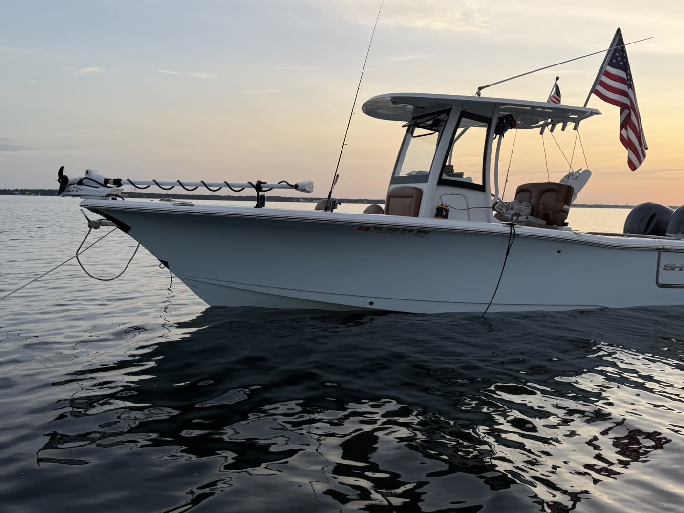 Big Fish Energy charter boat anchored at sunset with the American flag flying
