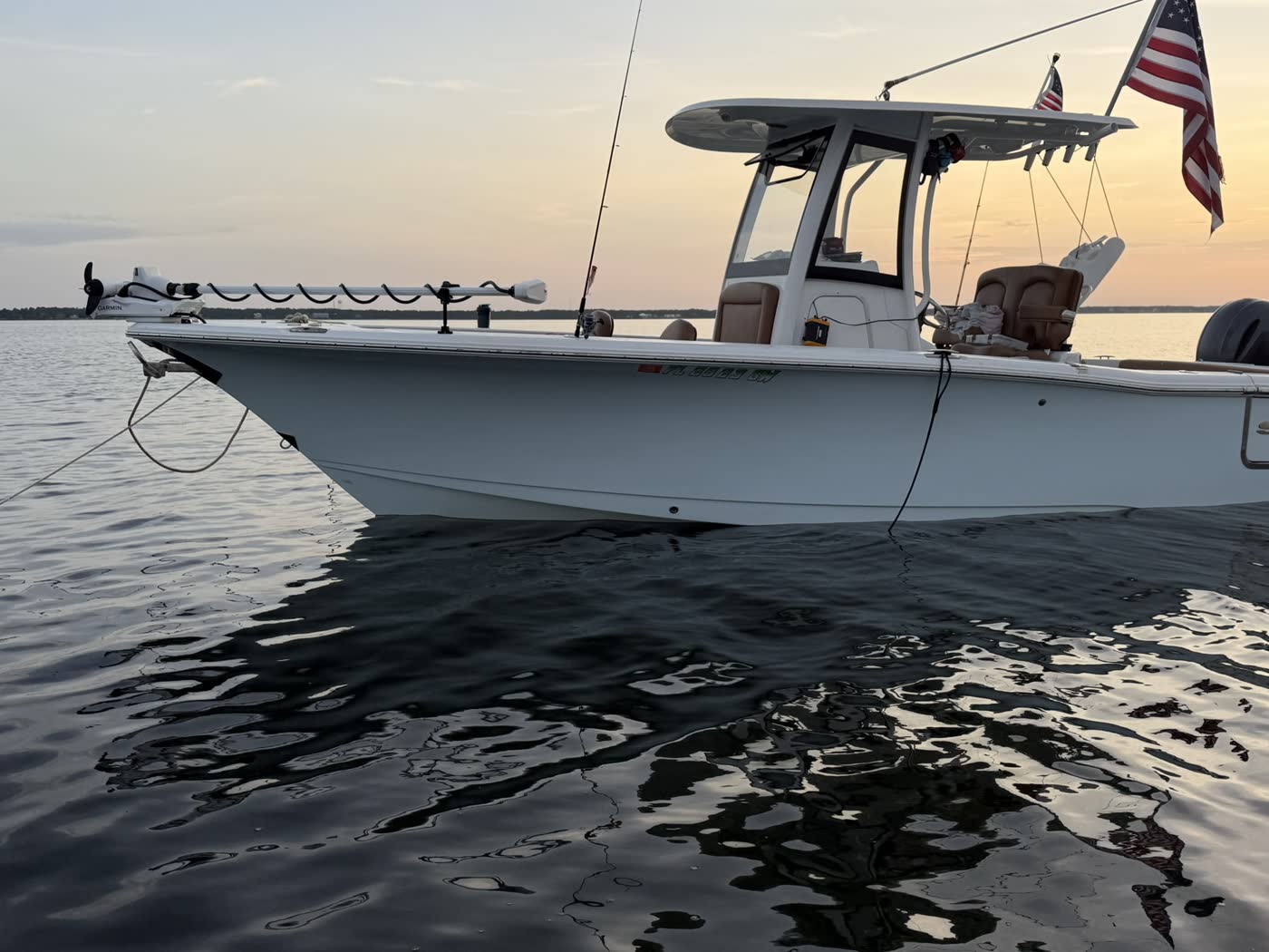Side profile of the Big Fish Energy charter boat on calm water at dusk