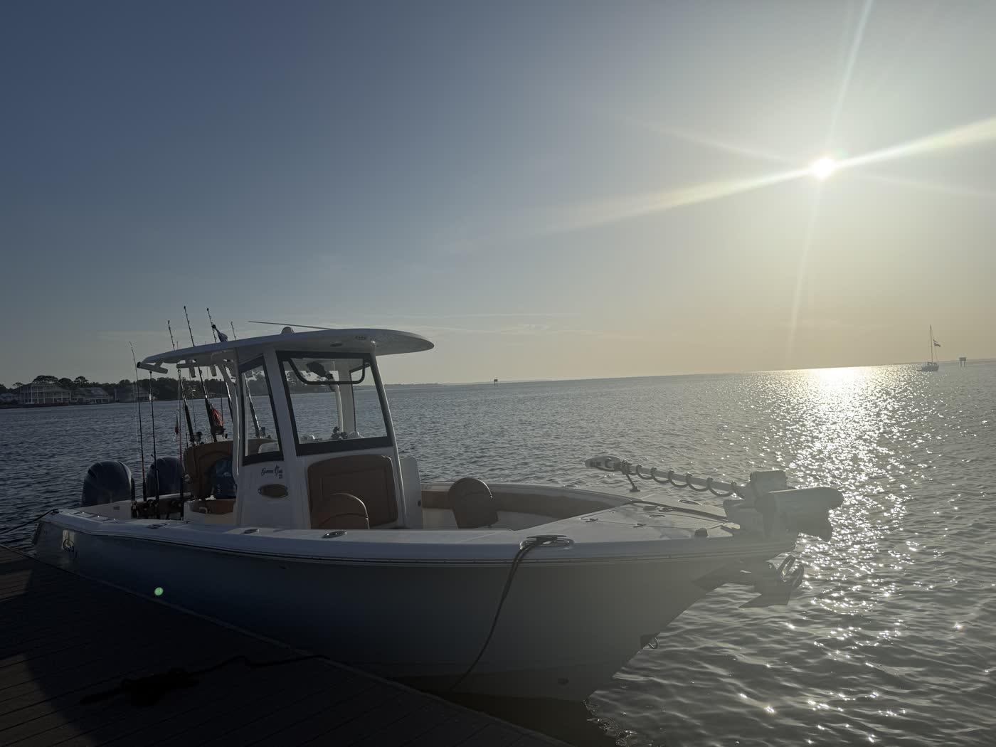 Big Fish Energy charter boat docked as the morning sun rises over the water
