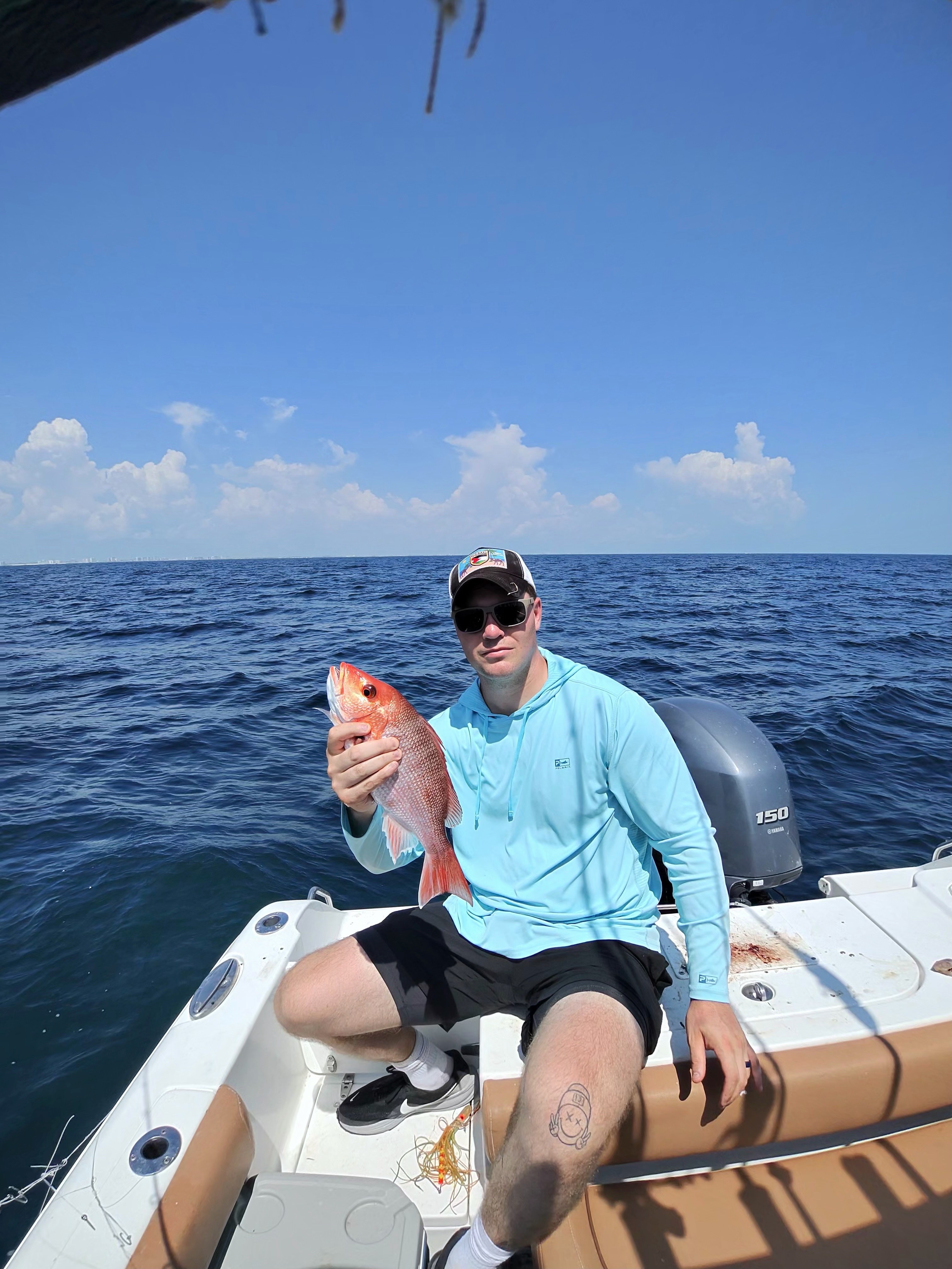 A customer holding a nice red snapper catch aboard the Big Fish Energy charter boat