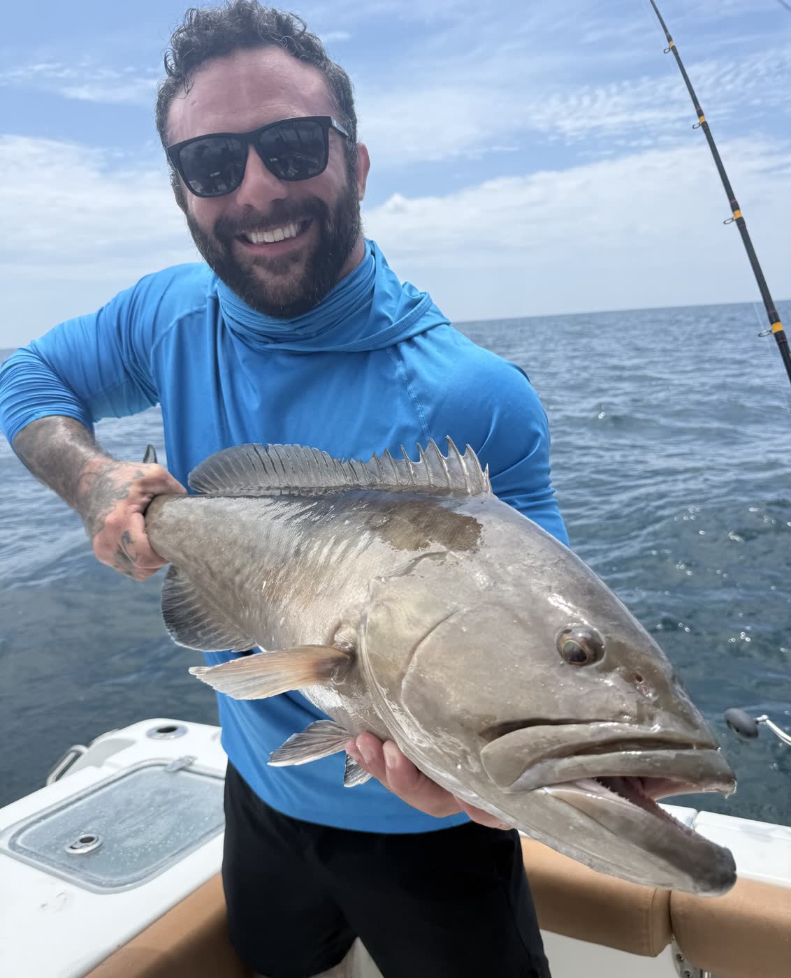 First mate Ray with a big grouper catch during a full-day offshore trip